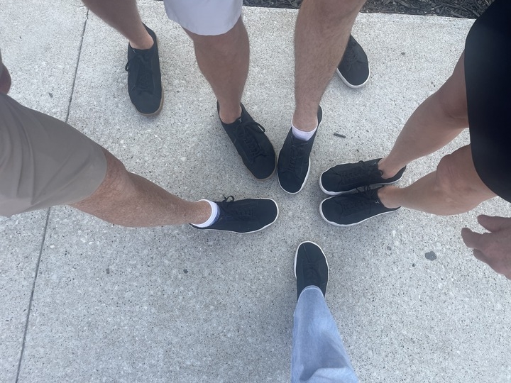 5 people showing off their flux footwear black trainer shoes